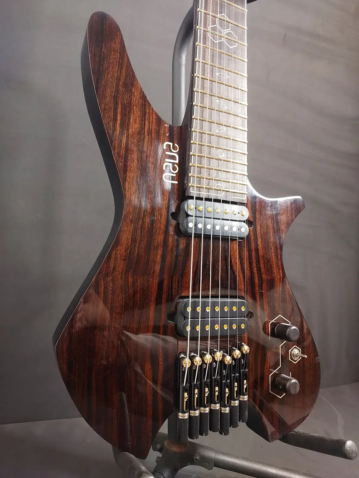 Nava Tabare body in figured wood with humbuckers and gold hardware