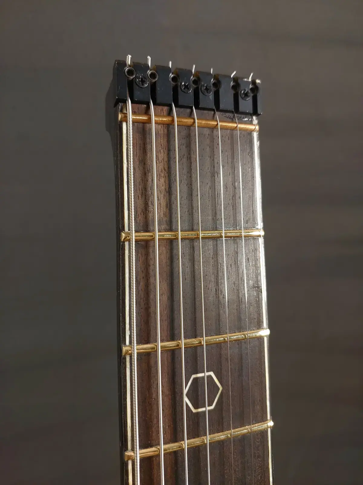 Nava Tabare fretboard with hexagon inlay